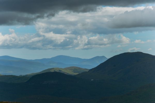Majestic mountains in County Kerry, Ireland with dramatic clouds overhead, showcasing natural beauty. Nature 4K