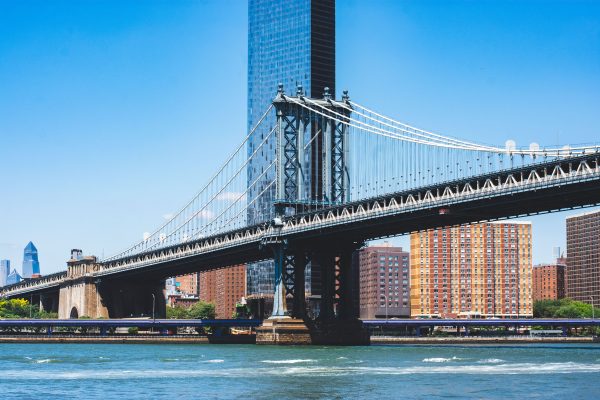 Manhattan Bridge spanning over the East River with New York City skyline in the background. Architecture 4K