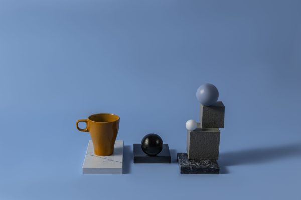 Modern minimalist composition with spheres and a cup on blue background. Perfect for abstract art themes. Minimaliste 4K
