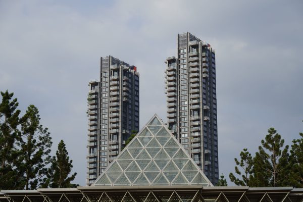 Modern skyscrapers and glass pyramid structure surrounded by greenery in Taipei, Taiwan. Architecture 4K