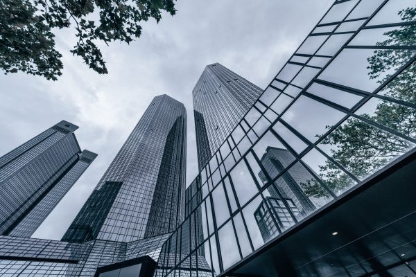 Modern skyscrapers with glass facades reflecting the urban skyline on an overcast day. Architecture 4K