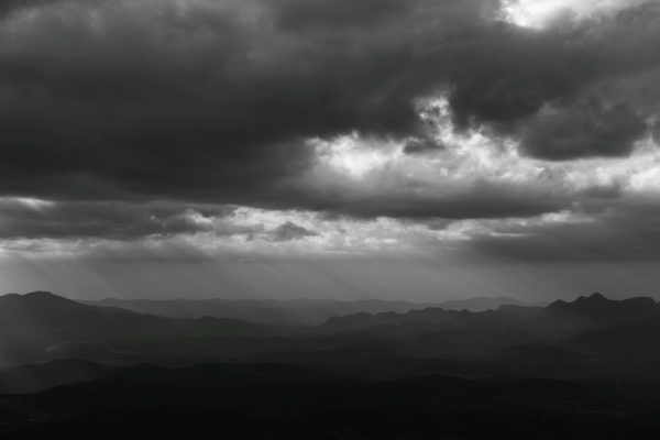 Moody black and white photo of cloudy mountains in Minas Gerais, Brazil. Dark 4K