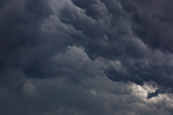 Moody sky filled with dense, dark clouds representing a dramatic atmosphere. Dark 4K