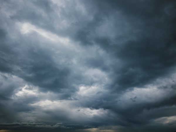 Moody sky with thick storm clouds, capturing the essence of an approaching storm. Dark 4K