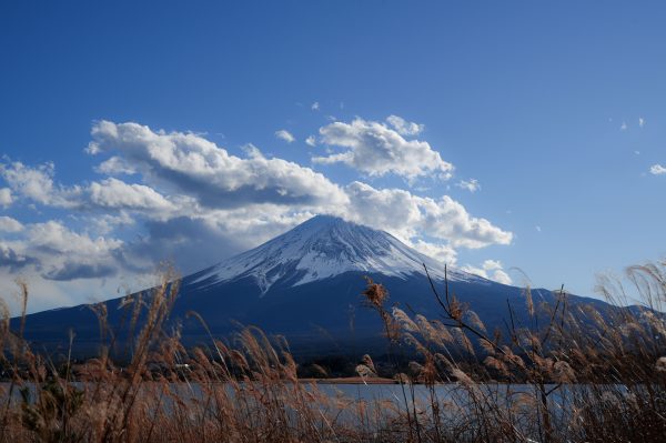Mount Fuji with vibrant sky and clouds, seen from lake in Japan. Anime 4K