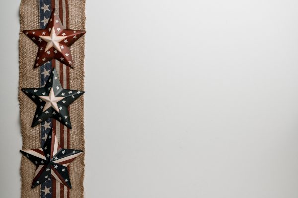 Overhead view of ribbon with stripes and stars representing liberty and democracy of USA on white background Espace 4K