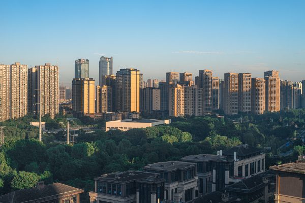 Panoramic view of a modern skyline with prominent skyscrapers and lush greenery. Architecture 4K