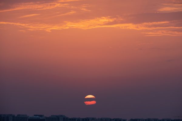 Peaceful cityscape sunset with vibrant orange and pink hues, perfect for tranquil landscapes. Nature 4K