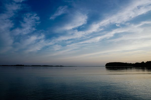 Peaceful ocean view under a sky painted with soft evening clouds. Nature 4K