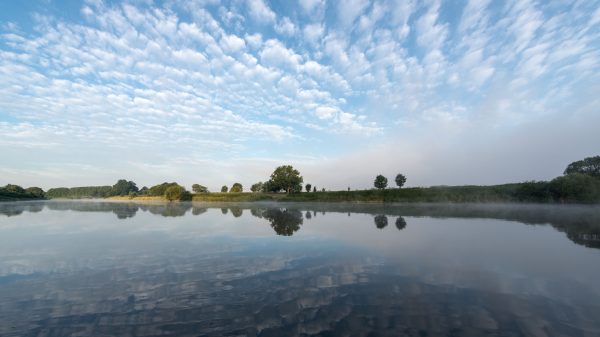 Peaceful river landscape with reflections in Höxter, Nordrhein-Westfalen. Nature 4K