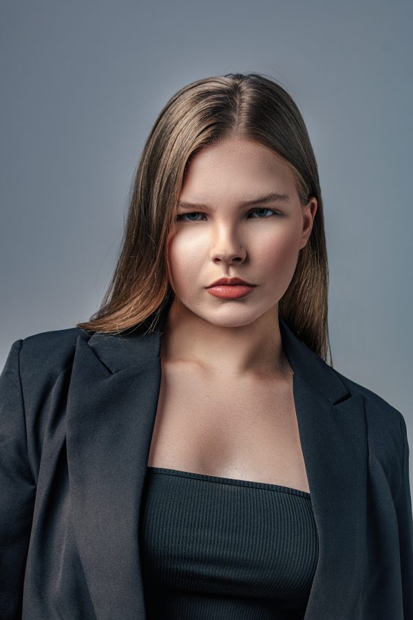 Portrait of a stylish woman in a black blazer showcasing modern fashion and elegance. Mobile 4K