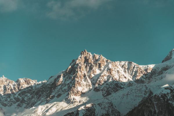 Scenic view of the snowcapped peaks of the French Alps with a vivid blue sky backdrop. Nature 4K