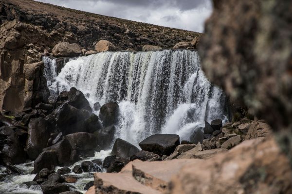 Scenic waterfall in Peru surrounded by rugged rocks and natural beauty, perfect for travel and nature photography. Nature 4K
