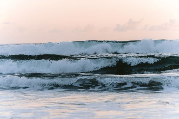 Serene evening waves crashing on the Pulukan shore in Bali, capturing nature's beauty. Nature 4K