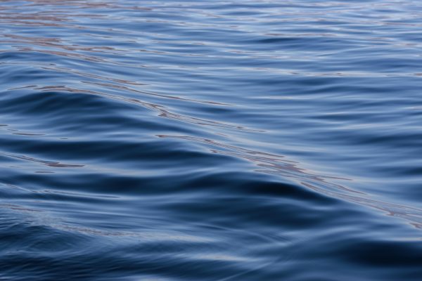 Serene ocean waves with smooth reflections create a tranquil seascape. Nature 4K