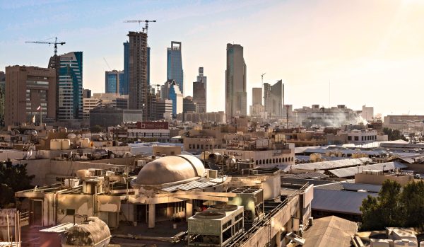 Skyline of Riyadh, Saudi Arabia featuring modern skyscrapers and construction cranes at sunset. Architecture 4K