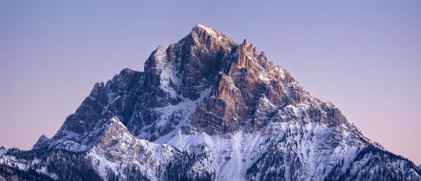 Snow-capped Dolomite peak under beautiful sunset sky, perfect for nature enthusiasts. Nature 4K