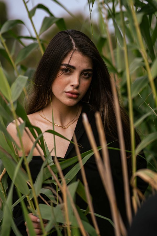 Striking portrait of a woman surrounded by lush greenery in Bandar Gaz, Iran. Mobile 4K