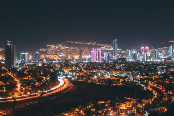 Stunning aerial shot of İzmir's vibrant cityscape, showcasing modern architecture and illuminated skyscrapers. Architecture 4K