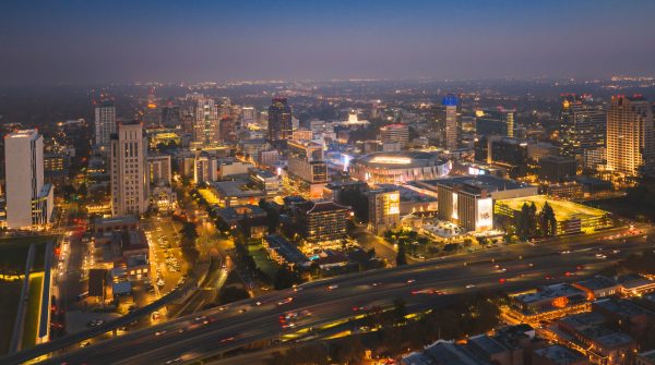 Stunning aerial view of Sacramento's city skyline illuminated at night, showcasing bustling urban life. Architecture 4K