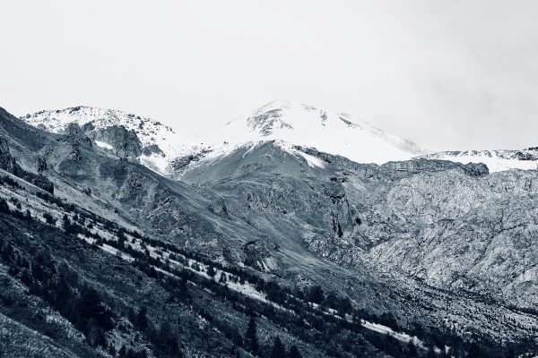 Stunning grayscale view of a snowy mountain peak, perfect for winter themes. Nature 4K