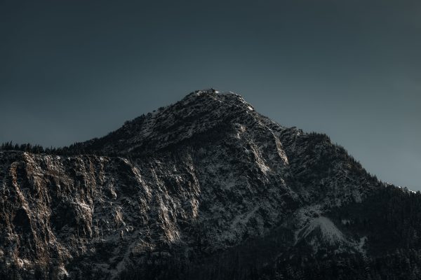 Stunning image of a snow-capped mountain peak under a clear sky, capturing nature's grandeur. Nature 4K