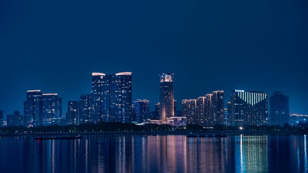 Stunning night view of Hangzhou's skyline reflecting on Qiantang River, showcasing modern architecture. Architecture 4K