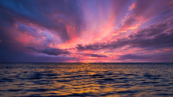 Stunning ocean view at sunset with colorful sky reflecting on the water. Nature 4K