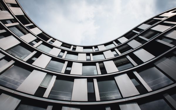 Stunning upward view of a modern curved building in Hamburg. A blend of glass and steel. Architecture 4K