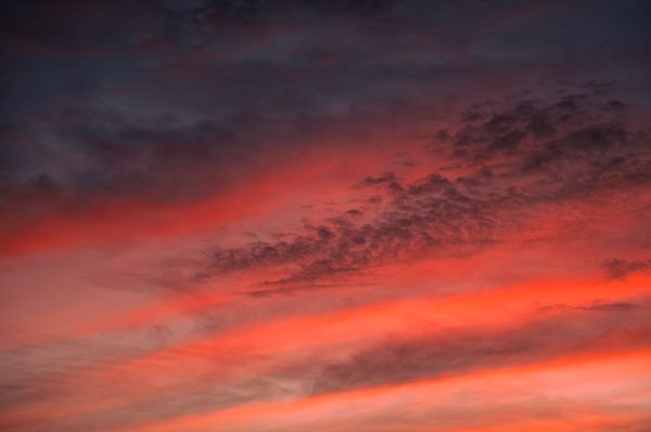 Stunning vibrant sunset sky with dramatic clouds and warm colors. Nature 4K