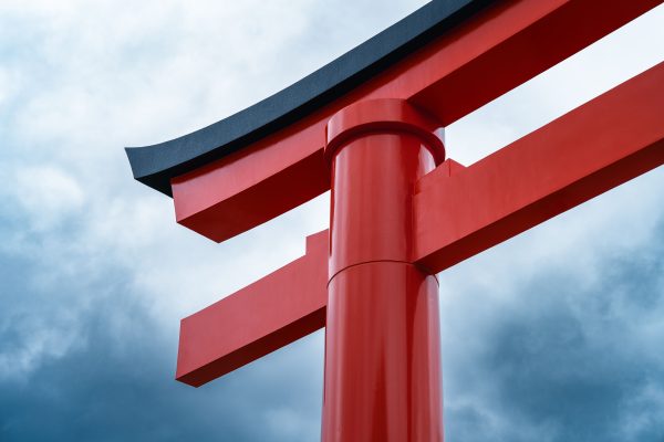 Stunning view of a red Torii gate in Kyoto, Japan, with a dramatic cloudy sky backdrop. Anime 4K