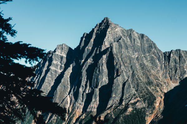 Stunning view of Jasper's Rocky Mountains with blue skies and rugged peaks. Nature 4K