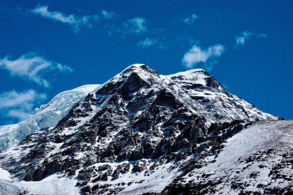 Stunning view of snow-covered mountain peaks under a clear blue sky in Tibet, China. Nature 4K