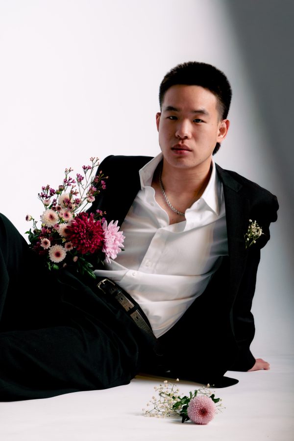 Stylish portrait of a man in a suit with a creative floral arrangement, indoors. Mobile 4K
