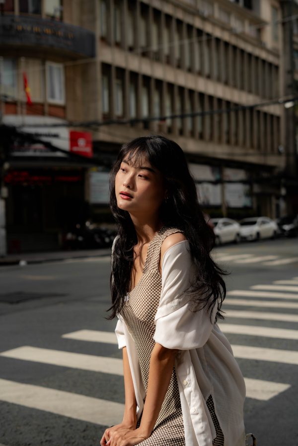 Stylish woman in urban setting, capturing fashion and city life in daylight. Mobile 4K