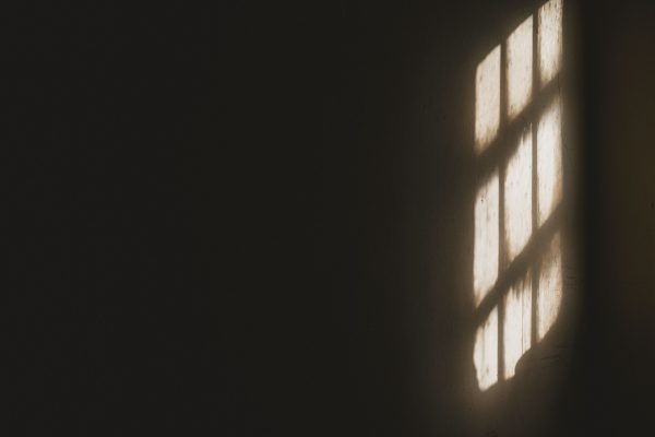 Sunlight casting window shadows on a dark wall creates a dramatic effect. Dark 4K
