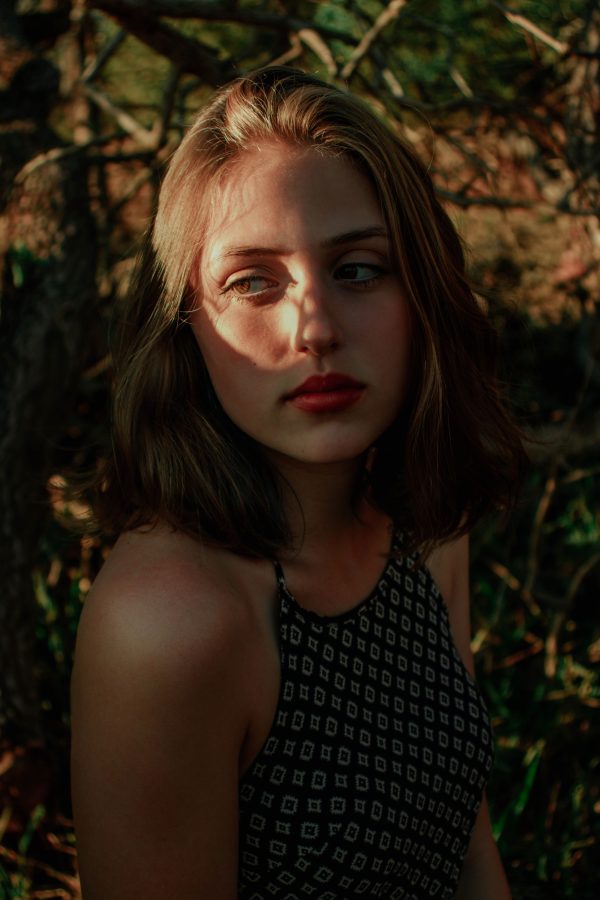 Thoughtful young female millennial in summer top relaxing in garden on sunny day and looking away dreamily Mobile 4K