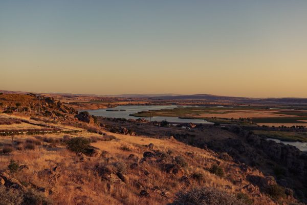 Tranquil aerial view of a vast landscape with a winding river at sunset. Nature 4K