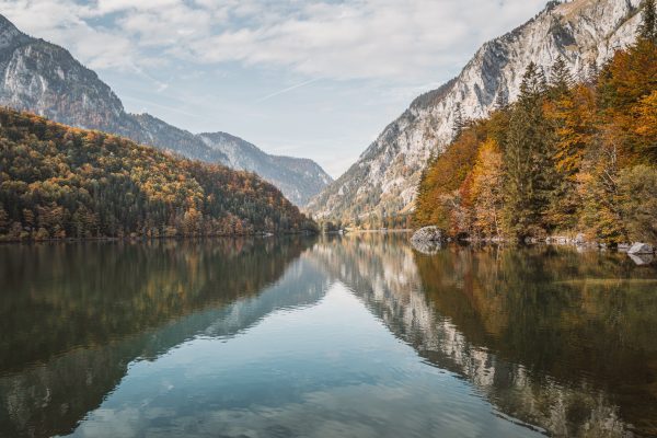 Tranquil scene of a mountain lake surrounded by autumn colors in Eisenerz, Austria. Nature 4K
