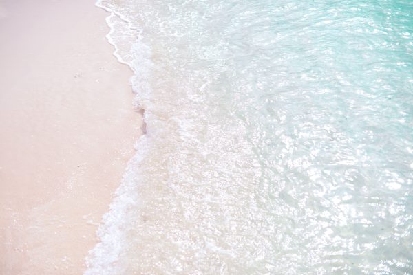 Tranquil scene of waves on a white sand beach, clear turquoise waters. Nature 4K