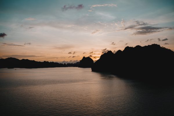 Tranquil sunset over Halong Bay, Vietnam with silhouette of limestone islands. Nature 4K