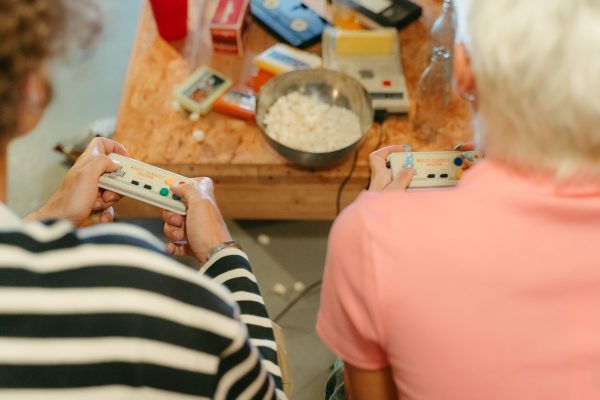 Two teenagers play video games together with snacks, creating a fun indoor atmosphere. Gaming 4K