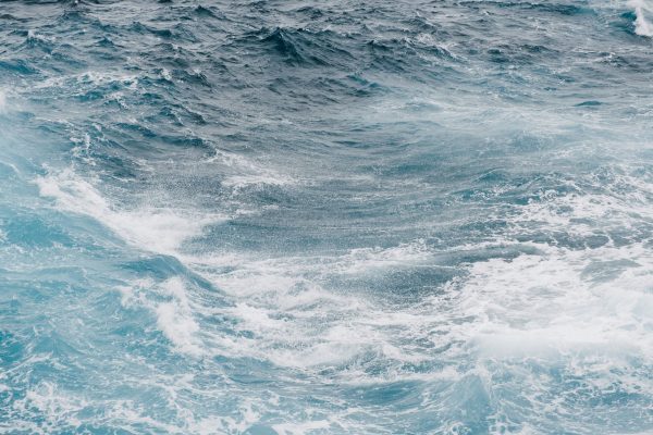 Vibrant and powerful ocean waves crashing and swirling in the sea, showcasing nature's beauty and energy. Nature 4K