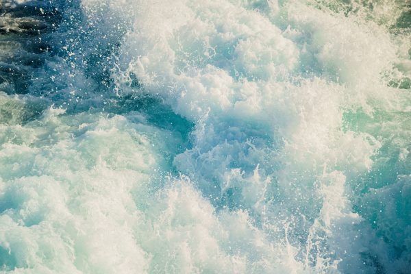 Vibrant ocean waves crashing with white foam, evoking a sense of energy and movement. Nature 4K