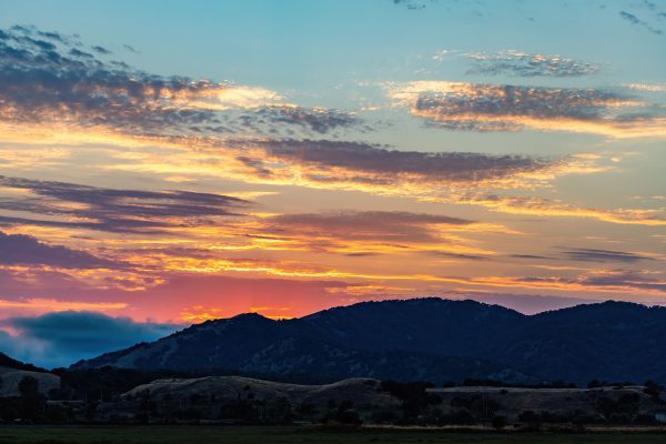 Vibrant sunset over mountains with colorful clouds in a stunning twilight scene. Nature 4K