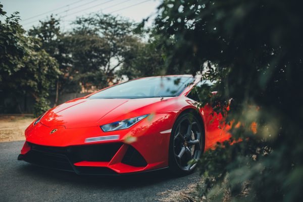 Vivid red Lamborghini Huracan parked outdoors in Gurugram, India, showcasing luxury automotive design. Voitures 4K