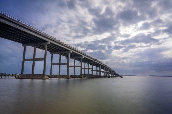 Washington Baum Bridge spans over calm water beneath a dramatic sky in North Carolina. Architecture 4K
